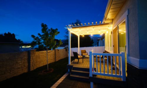 A backyard of a suburban USA home with a deck and pergola. A backyard of a suburban USA home with a deck and pergola.